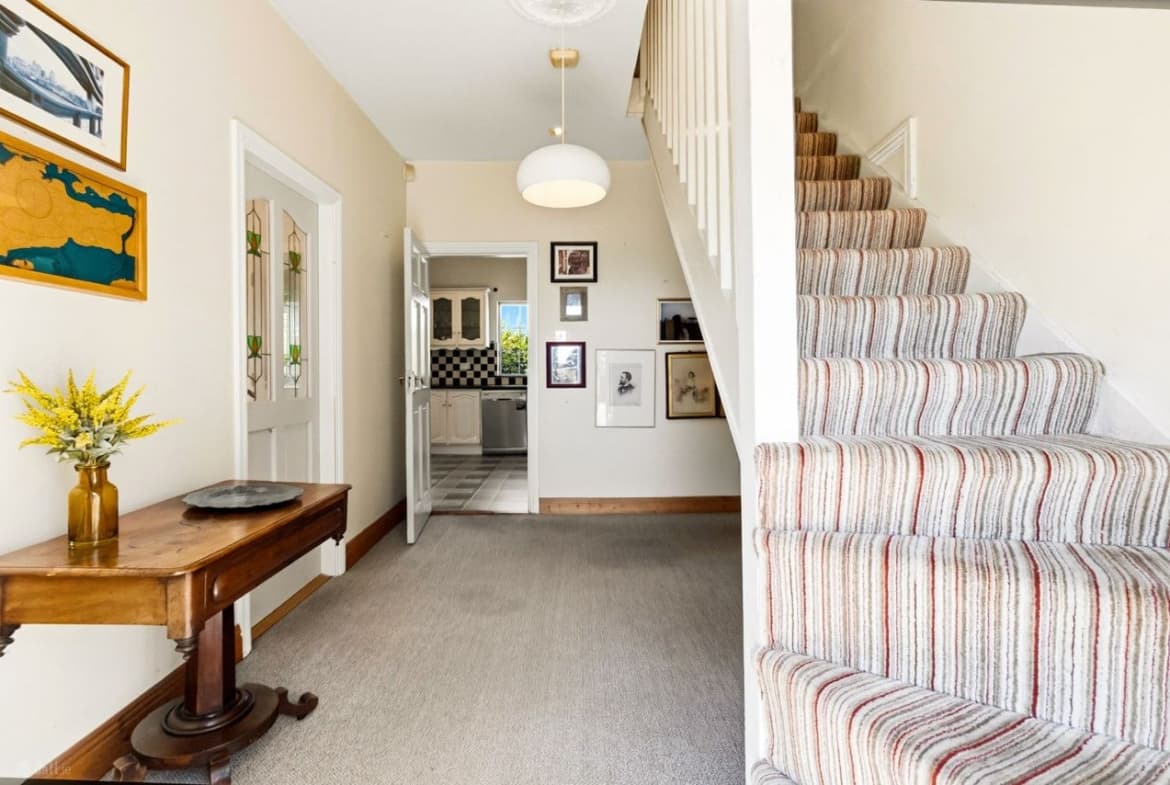Entrance hallway with carpeted staircase