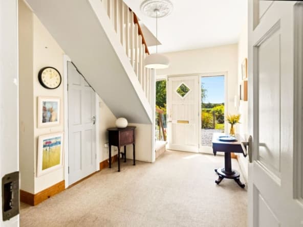 Hallway leading to staircase and front door