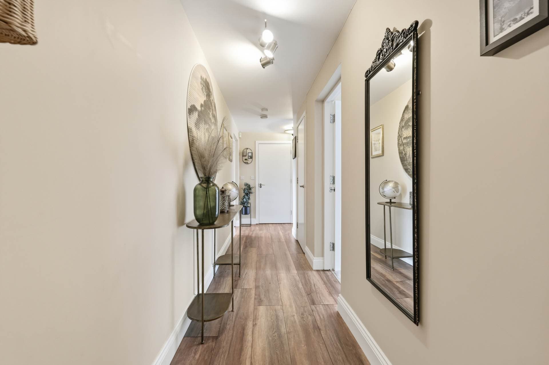 Entrance hallway with wood flooring and decorative mirror