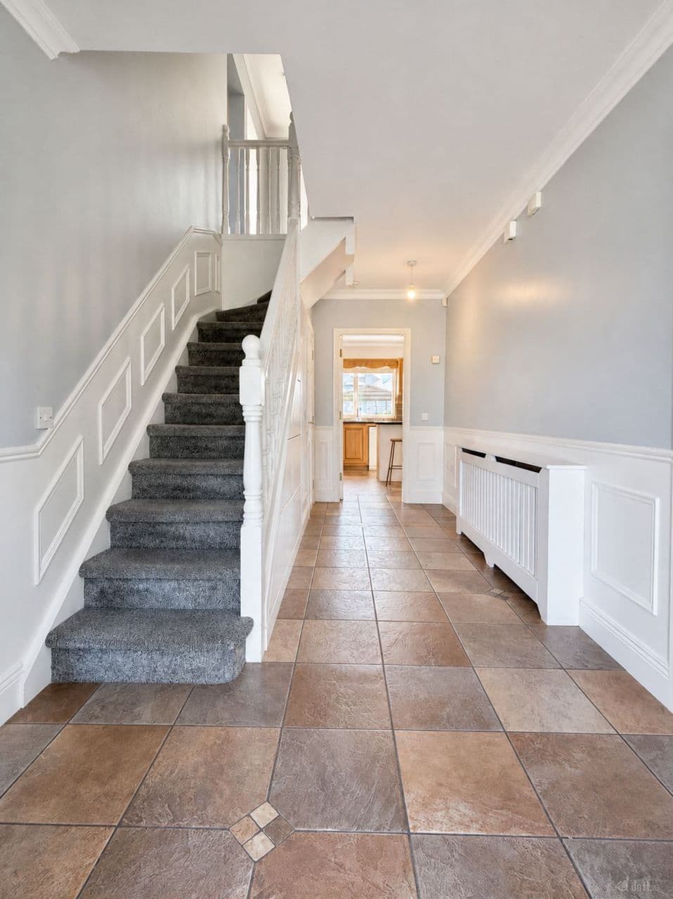 Entrance hallway with staircase and custom wall panelling