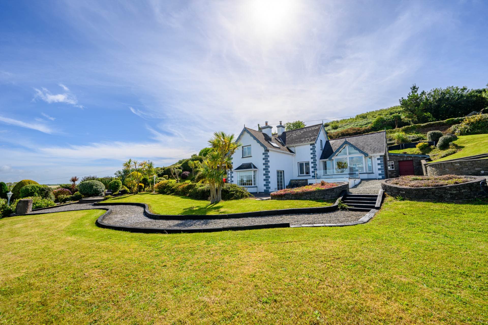 Front exterior of Mount Seaview with terraced gardens and gravel driveway