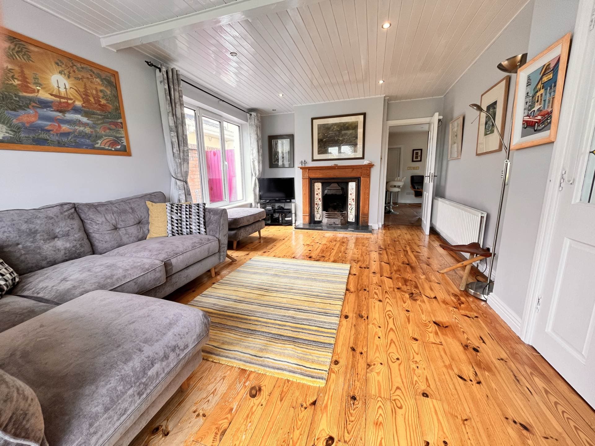 Living room with feature fireplace and wooden flooring