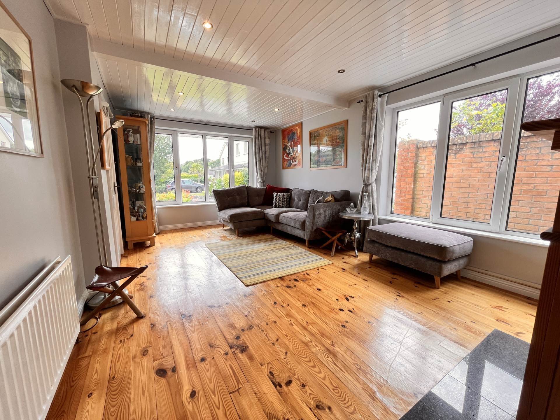 Front family room with corner sofa and bay window