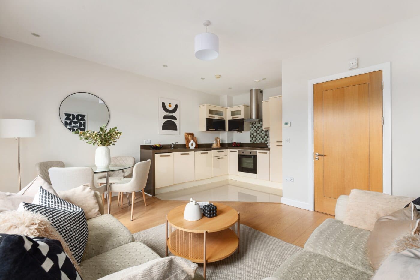 Open-plan kitchen, dining and living area with high-gloss cabinetry